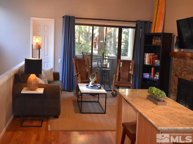 a dining room with furniture and a flat screen tv