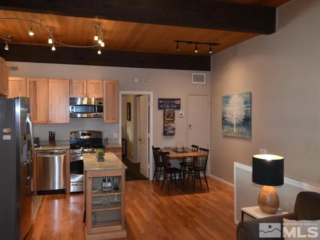 a dining room with furniture and a kitchen view
