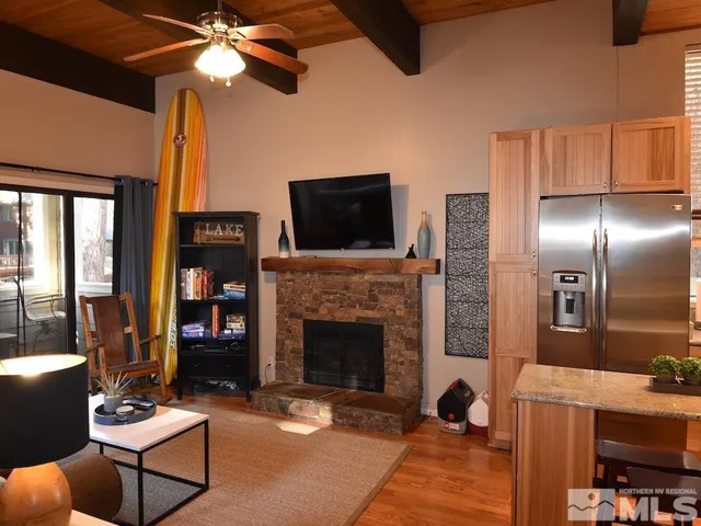 a living room with furniture a flat screen tv and a fireplace
