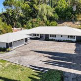 a view of a white house with a yard