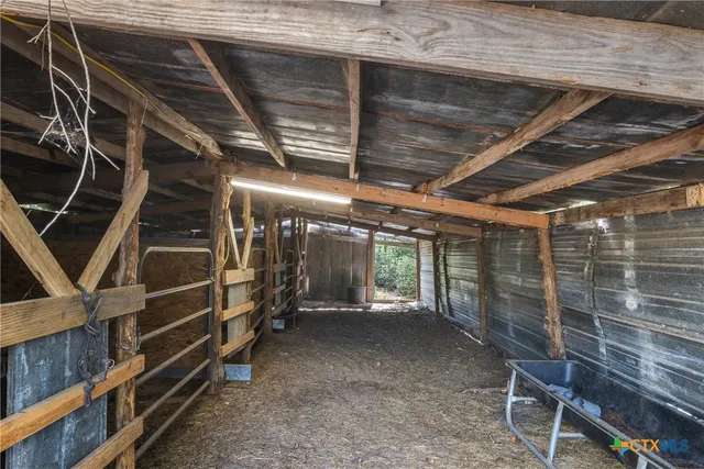 a view of a dry yard with wooden fence