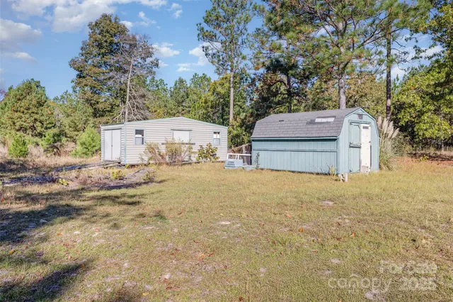 a white house that has a tree in front of it