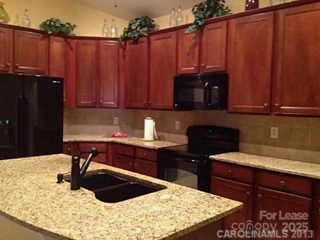 a kitchen with a cabinets and chairs