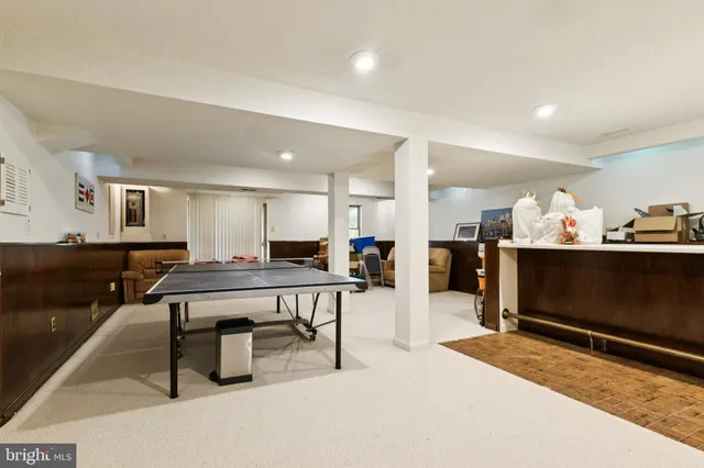 a living room with furniture a flat screen tv and a table