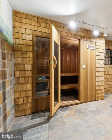 a view of a hallway with wooden shelves