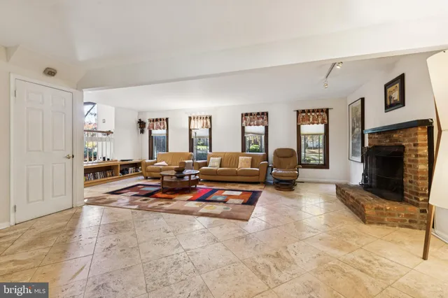 a living room with patio furniture and a fireplace