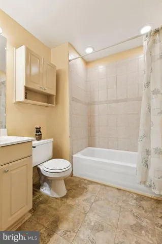 a bathroom with a toilet a sink and bathtub