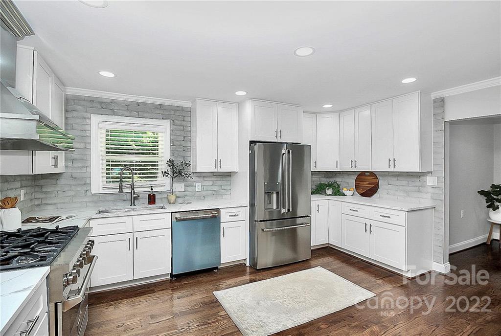 225 Morning Dale Road Matthews, NC 28105 - Photo 13 of 48 a kitchen with white cabinets and white appliances