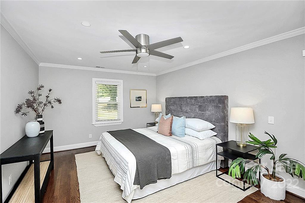 225 Morning Dale Road Matthews, NC 28105 - Photo 20 of 48 a bedroom with a bed and a chandelier