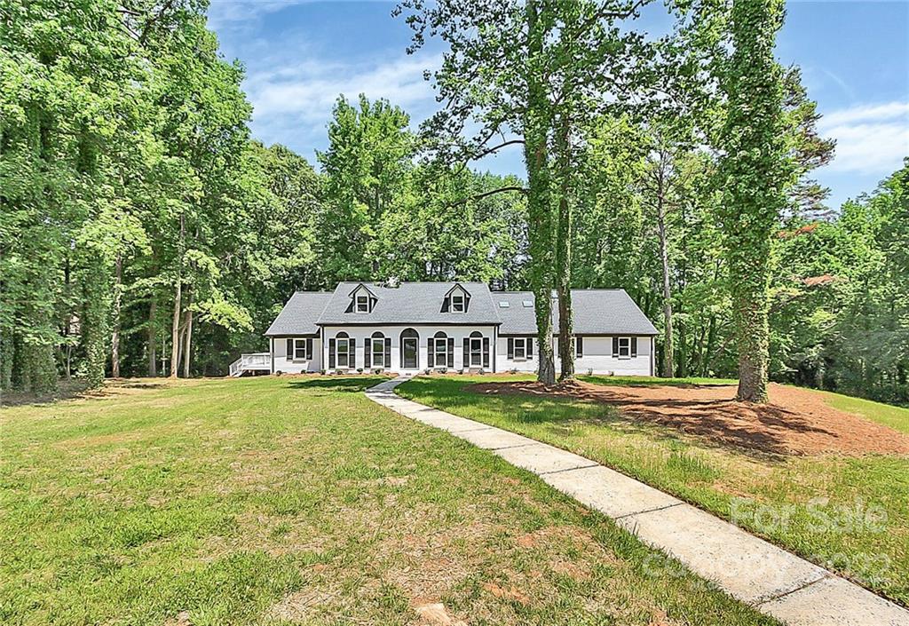 225 Morning Dale Road Matthews, NC 28105 - Photo 2 of 48 a front view of a house with a yard and trees