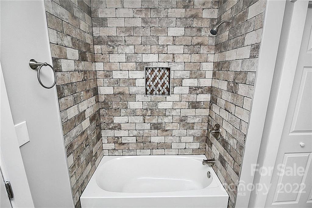 225 Morning Dale Road Matthews, NC 28105 - Photo 28 of 48 a bathroom with a bathtub