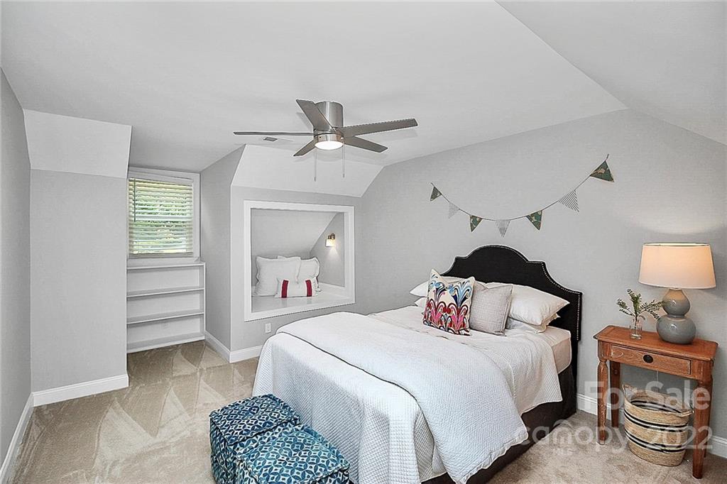 225 Morning Dale Road Matthews, NC 28105 - Photo 41 of 48 a bedroom with a bed and a chandelier