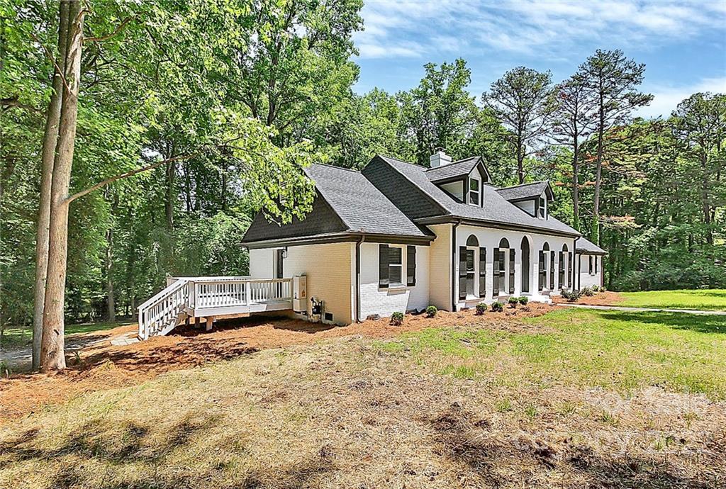 225 Morning Dale Road Matthews, NC 28105 - Photo 46 of 48 a front view of a house with a yard and trees