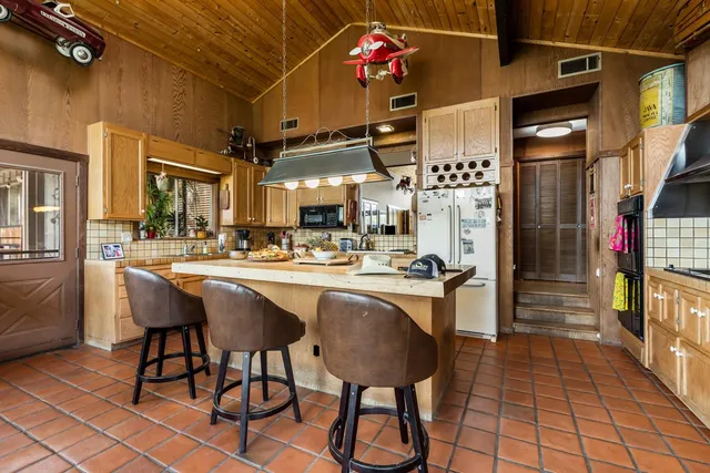 a kitchen with stainless steel appliances granite countertop a sink and cabinets