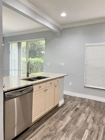 a kitchen with granite countertop white cabinets and a granite counter tops with a large window