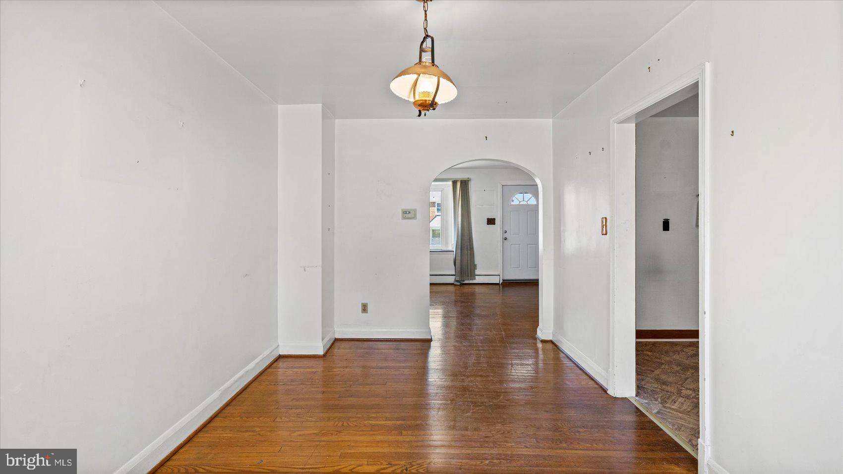 1805 Crestview Road Baltimore, MD 21239 - Photo 9 of 39 a view of empty room with wooden floor and window