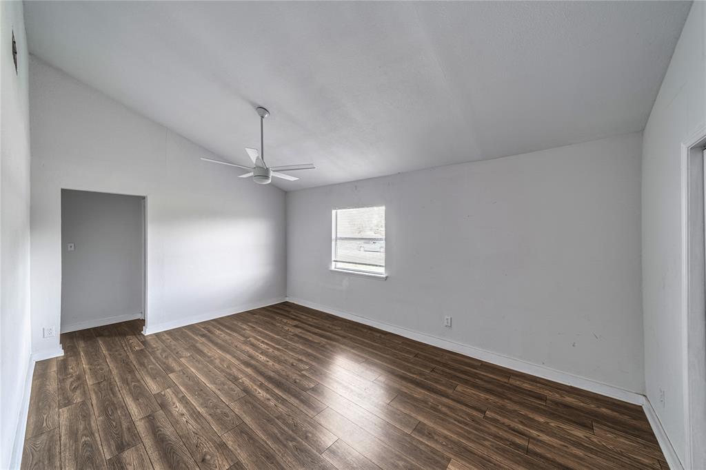 500 County Road 3724 Wills Point, TX 75169 - Photo 14 of 32 an empty room with wooden floor ceiling fan and windows