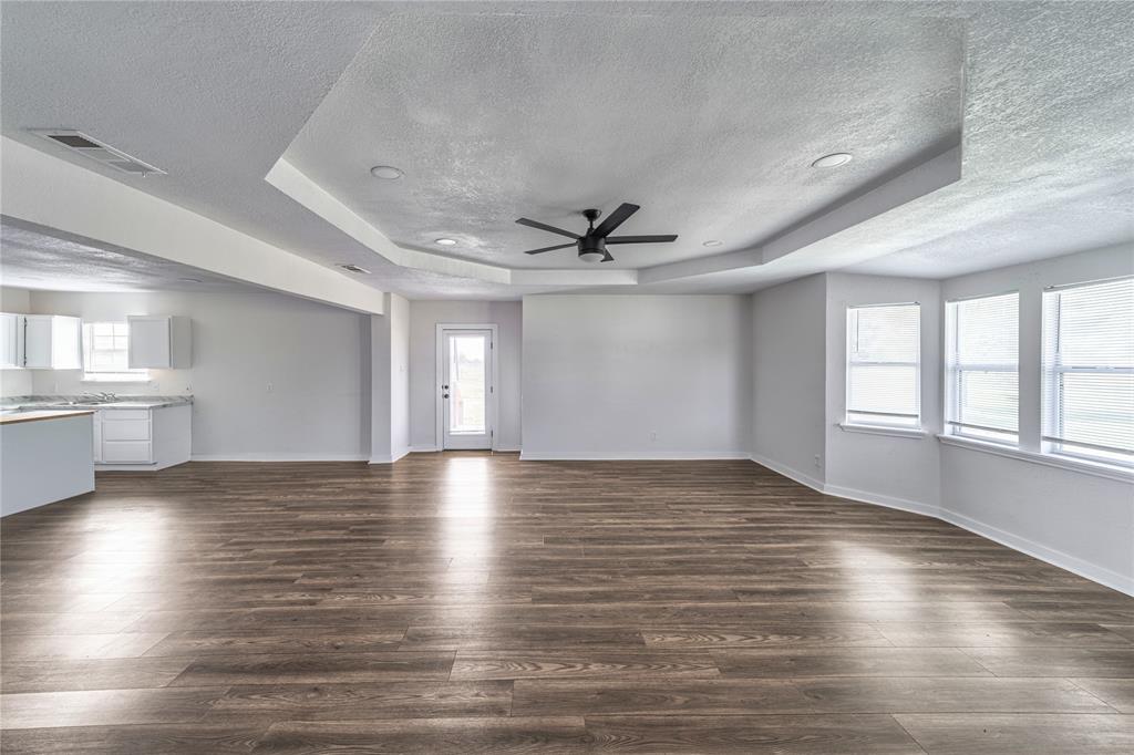 500 County Road 3724 Wills Point, TX 75169 - Photo 7 of 32 an empty room with wooden floor and windows