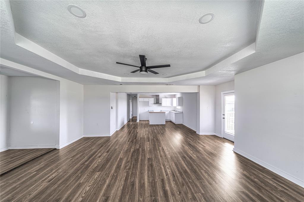 500 County Road 3724 Wills Point, TX 75169 - Photo 8 of 32 a view of a room with wooden floor ceiling fan and windows