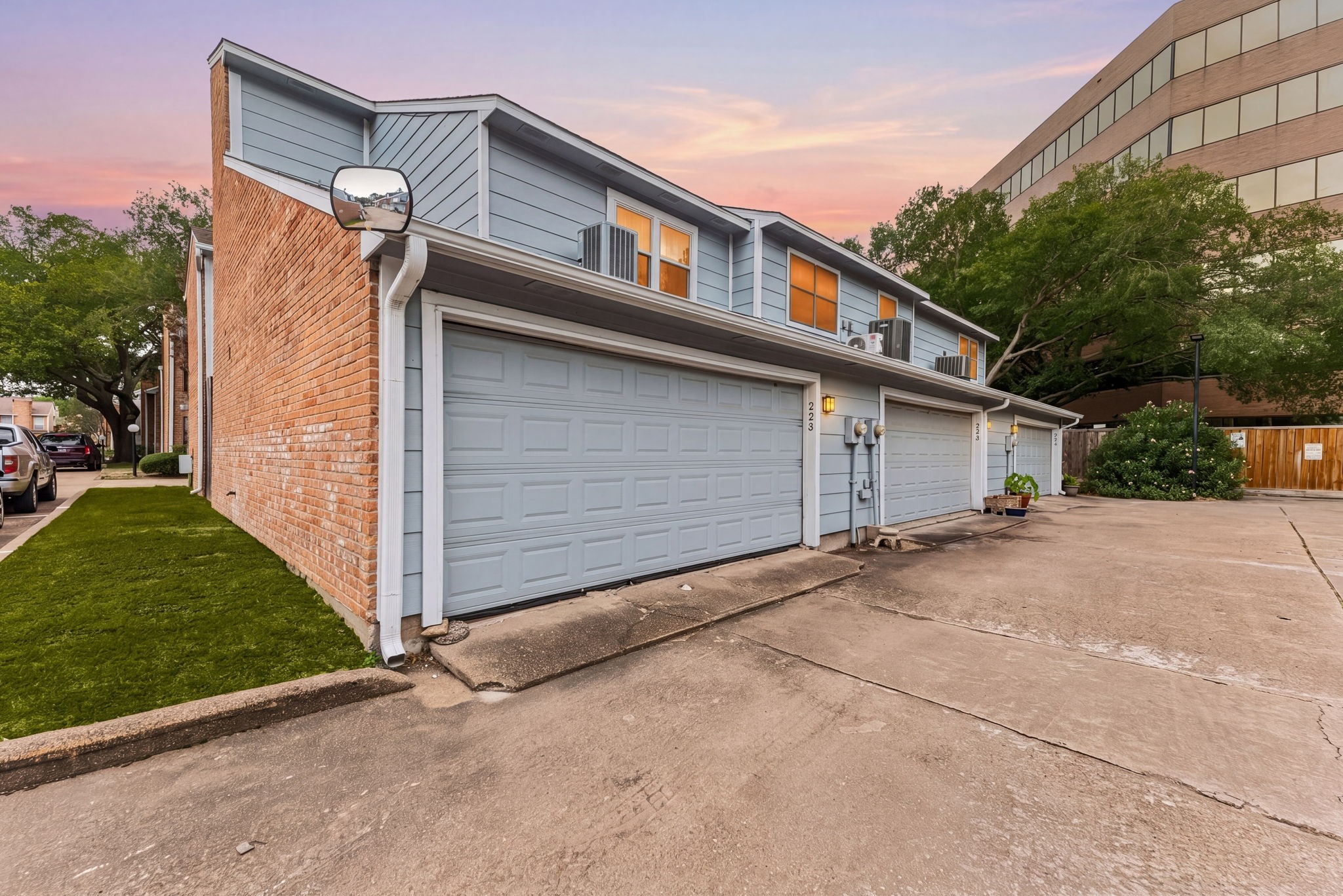 3200 South Gessner Road, Unit 228 Houston, TX 77063 - Photo 15 of 18 Garage/Rear Exterior Twilight:
The attached garage provides convenient and secure parking, while the warm glow of the windows against a stunning Houston twilight sky makes coming home feel like a dream.
