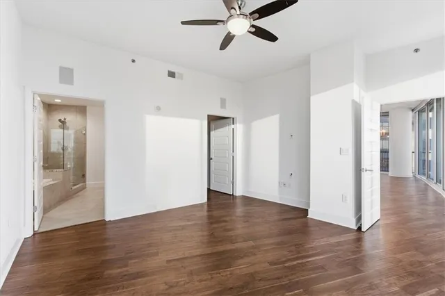 a view of an empty room with wooden floor