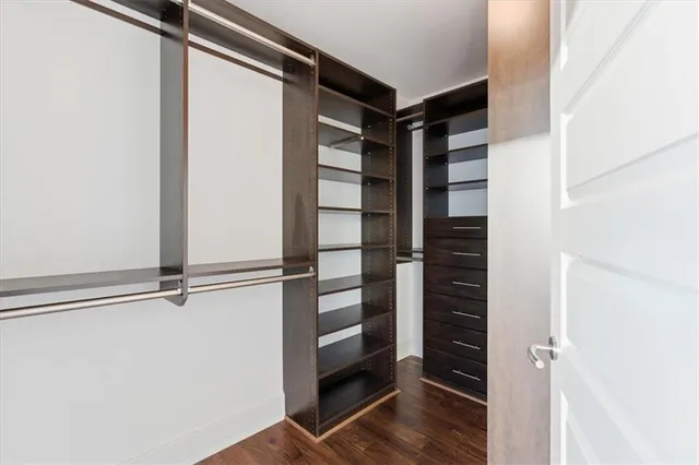 a view of walk in closet with empty racks