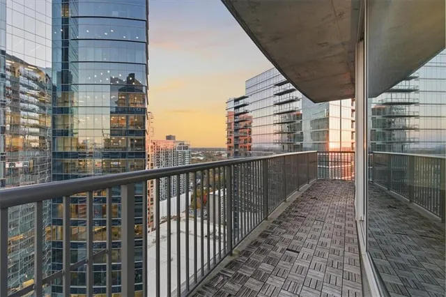 a view of a balcony with a floor to ceiling window and wooden floor