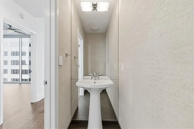 a bathroom with a sink a mirror and a toilet