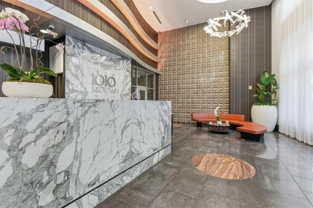 a bedroom with furniture and a potted plant