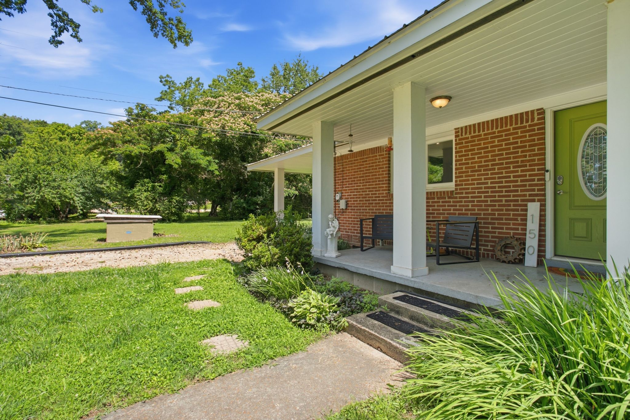 150 Toms Creek Road Linden, TN 37096 - Photo 15 of 23 a front view of a house with garden