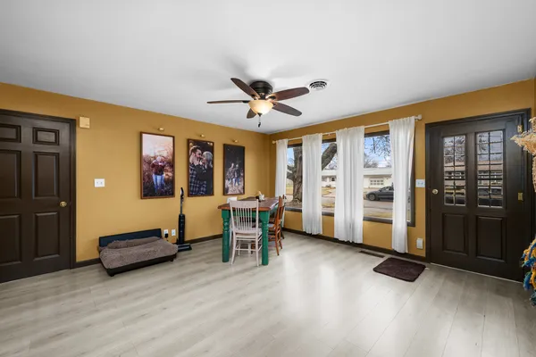 a living room with furniture gym equipment and a large window