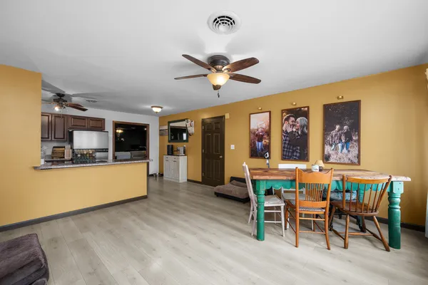 a view of a dining room with furniture window and wooden floor