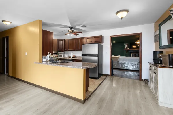 a kitchen with kitchen island a counter top space a sink stainless steel appliances and cabinets