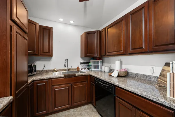 a kitchen with stainless steel appliances granite countertop a sink stove and cabinets