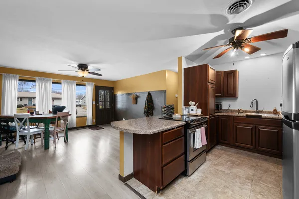 a kitchen with stainless steel appliances granite countertop a stove and cabinets