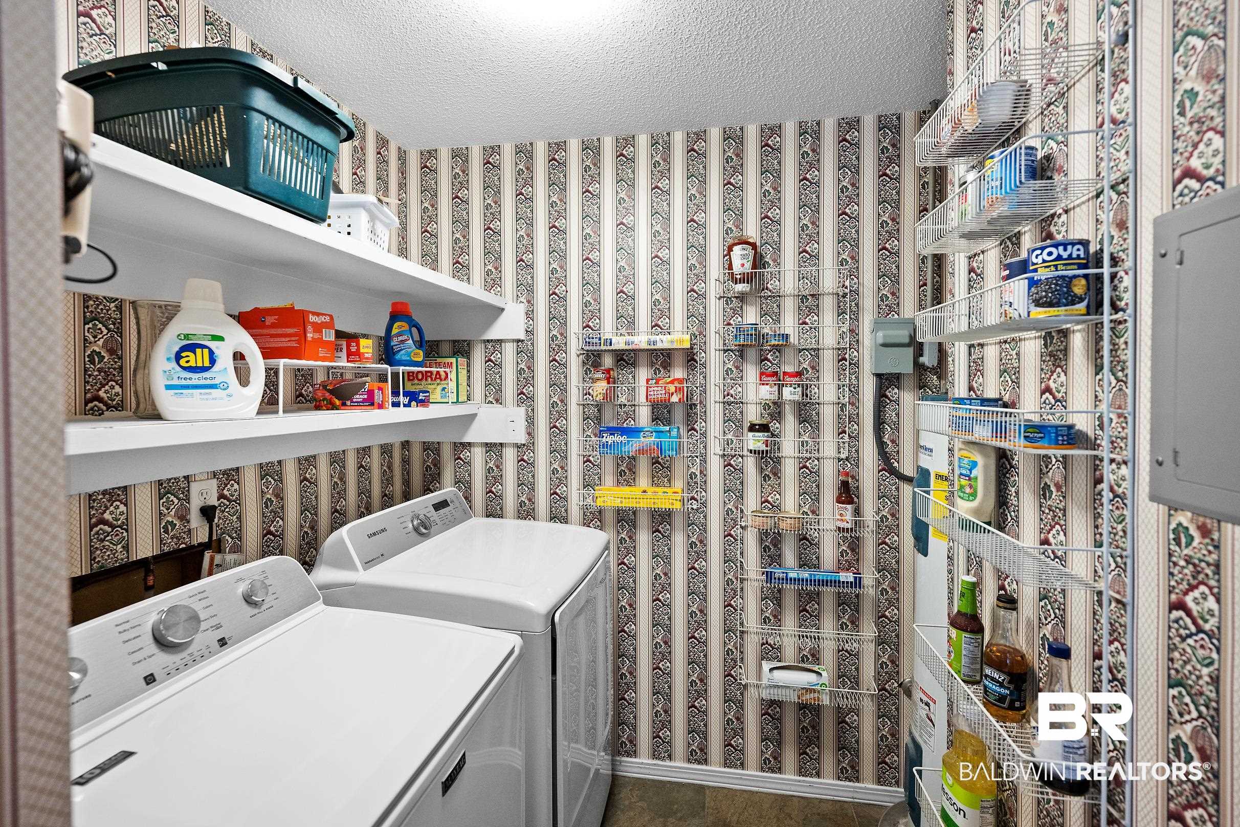 4026 Kingsrow Row Mobile, AL 36619 - Photo 38 of 51 Laundry area with wallpapered walls, a textured ceiling, washing machine and dryer, and electric panel