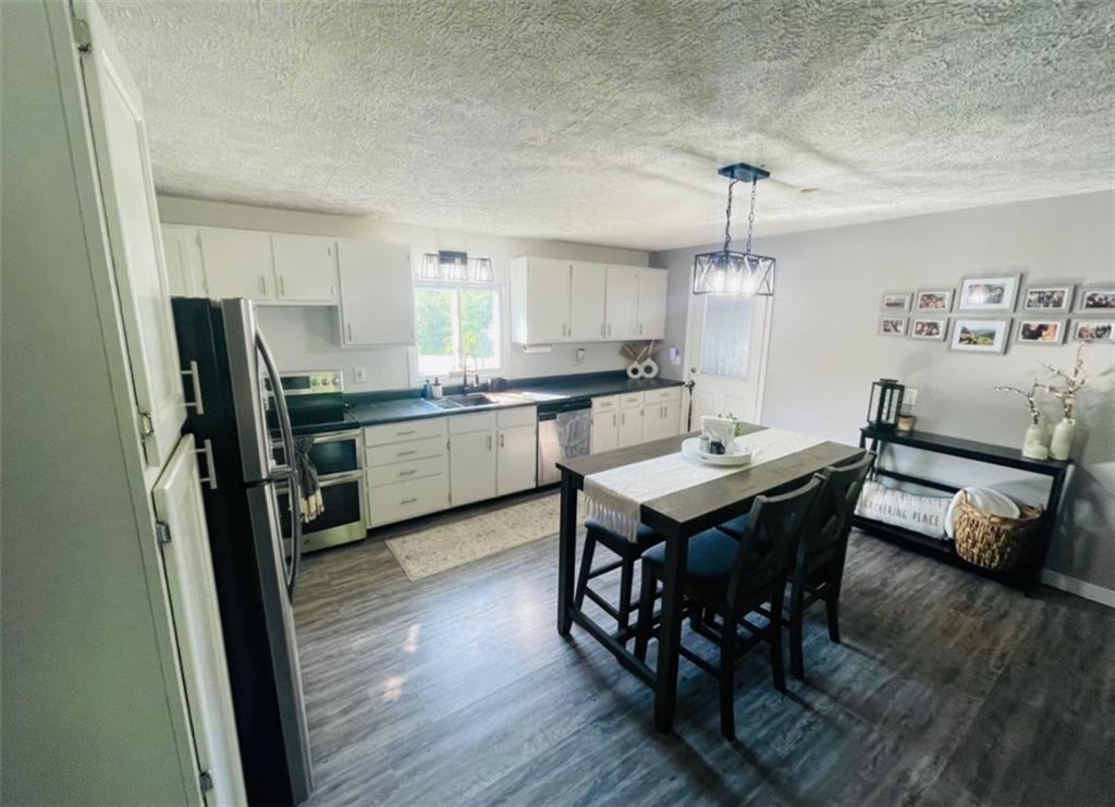 839 Methodist Road Greenville, PA 16125 - Photo 3 of 21 a view of a dining room with furniture and wooden floor