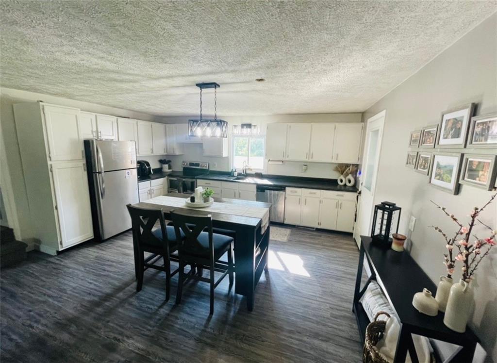 839 Methodist Road Greenville, PA 16125 - Photo 5 of 21 a kitchen with stainless steel appliances a dining table chairs and wooden floor