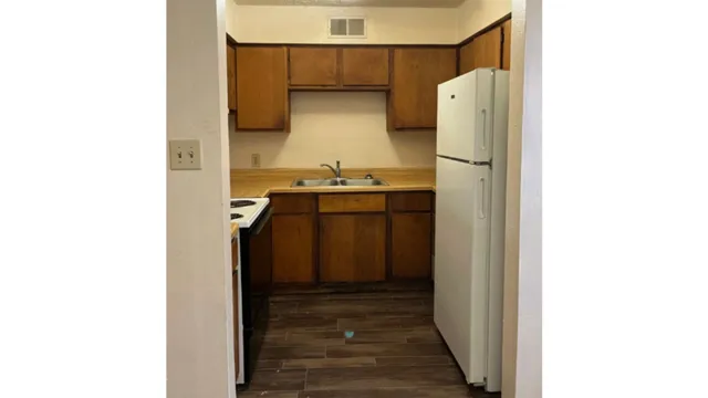 a kitchen with a refrigerator and a stove