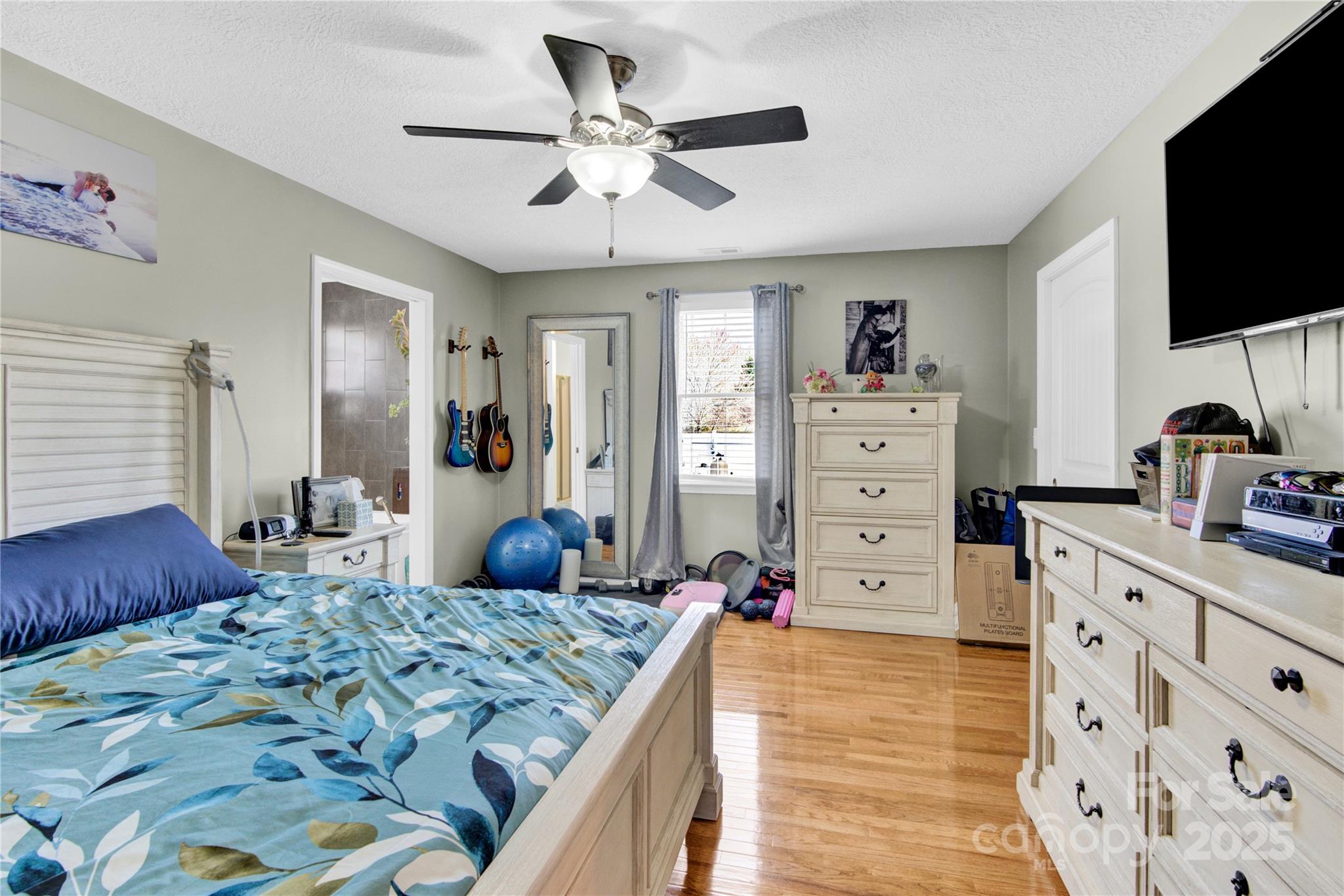 1659 Buffett Circle Hickory, NC 28602 - Photo 20 of 46 a bedroom with a bed and a flat tv screen on dresser