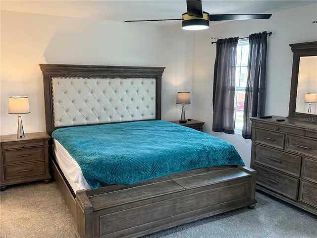 a bedroom with a bed and a dresser