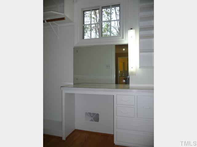 122 Lord Ashley Road Raleigh, NC 27610 - Photo 11 of 25 A built-in dressing table is an original part of the charming and functional walk-in closet in the Master Bedroom.
