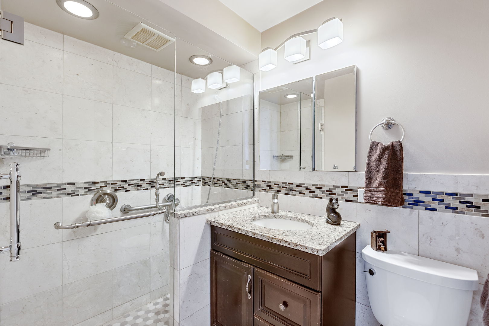 655 West Irving Park Road, Unit 1806 Chicago, IL 60613 - Photo 13 of 35 a bathroom with a granite countertop sink and a mirror