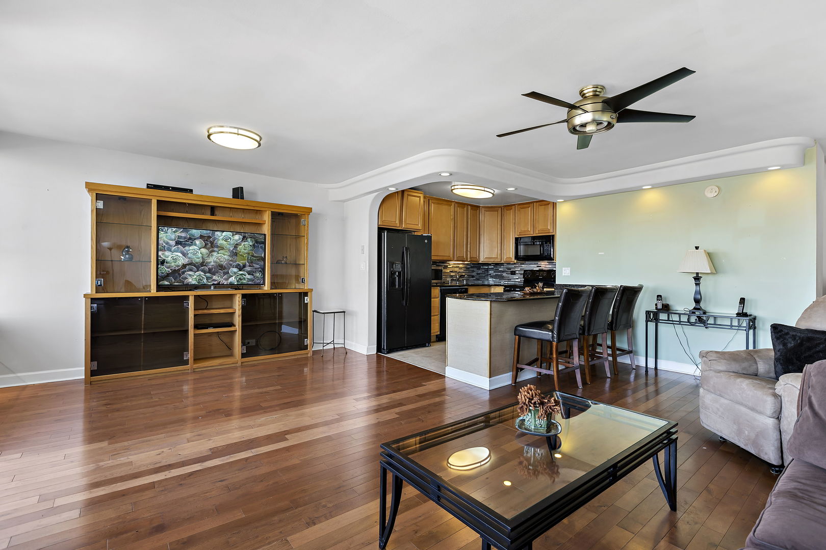 655 West Irving Park Road, Unit 1806 Chicago, IL 60613 - Photo 5 of 35 a living room with stainless steel appliances kitchen island granite countertop furniture and a view of kitchen
