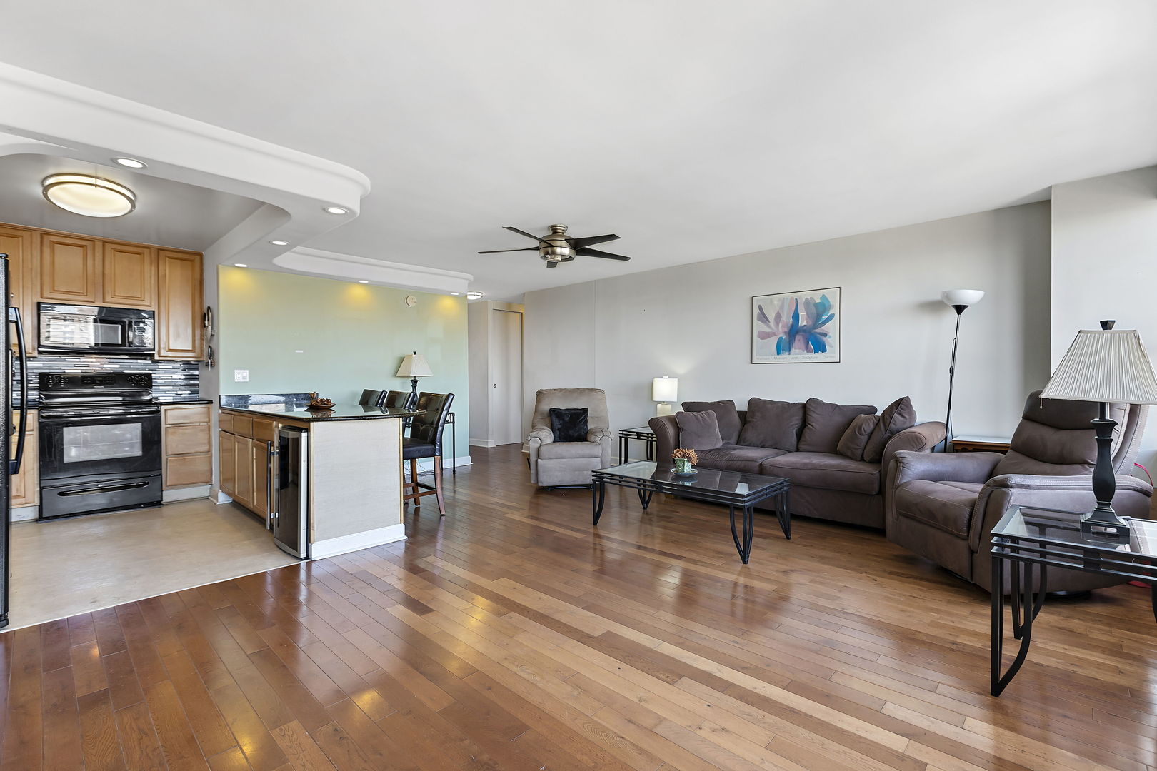 655 West Irving Park Road, Unit 1806 Chicago, IL 60613 - Photo 6 of 35 a living room with furniture kitchen view and a wooden floor