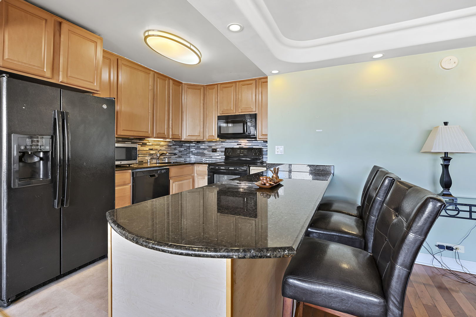 655 West Irving Park Road, Unit 1806 Chicago, IL 60613 - Photo 8 of 35 a kitchen with a table chairs refrigerator and microwave