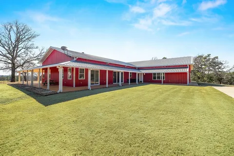 a view of house with swimming pool outdoor seating