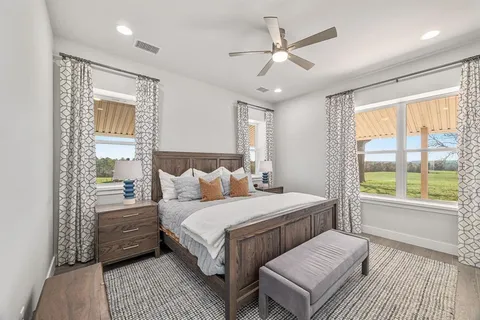 a bedroom with a large bed and a large window