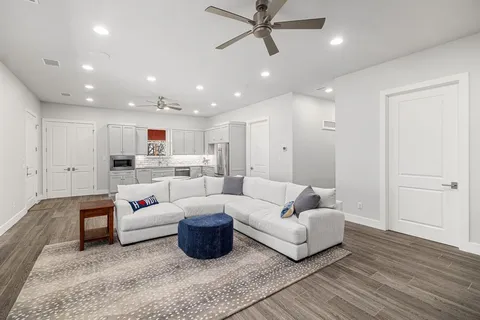 a living room with furniture and kitchen view