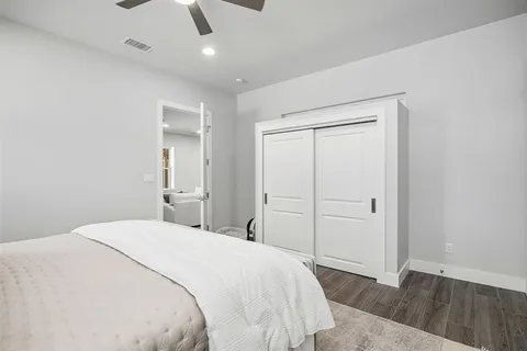 a bedroom with a bed and wooden floor